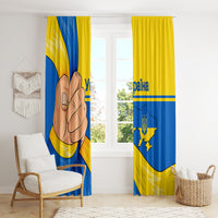 Blue and yellow curtain panels with trident emblem and Ukraine map graphic, hanging straight