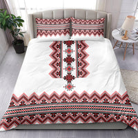 White duvet and pillow set with red, black embroidered-style folk band pattern