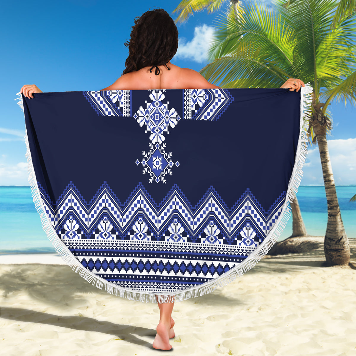 Navy blue round beach blanket with white folk motif and fringed edge