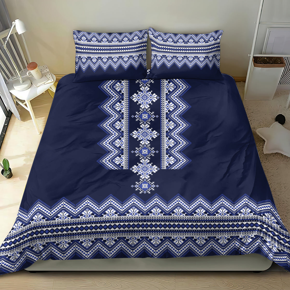Navy blue duvet cover with bold white-blue folk border pattern and two matching pillowcases