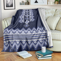 Ukrainian folk pattern blanket folded on sofa, dark navy with blue-and-white banded motifs