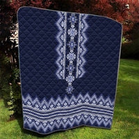 Folded navy blue quilt with white-blue folk pattern panel and repeating zigzag band