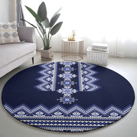 Round navy blue rug with wide vertical stripes and white geometric motifs