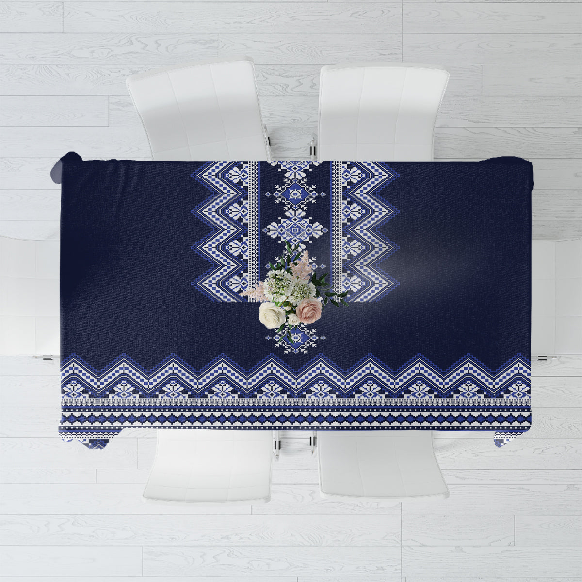 Navy blue folk patterned tablecloth with blue-and-white geometric border and center motif