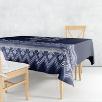 Navy blue tablecloth draped over a dining table with blue-and-white folk geometric pattern