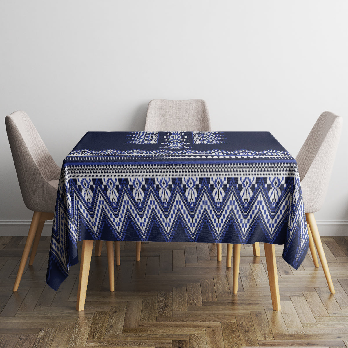 Navy blue folk patterned tablecloth with blue-and-white geometric border on square table