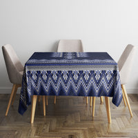 Navy blue folk patterned tablecloth with blue-and-white geometric border on square table