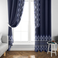 Navy folk pattern curtain on a white window with vertical decorative trim and zigzag hem.