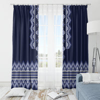 Navy folk pattern curtains with top rings and white geometric panels over a bright window.