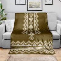 Brown folk geometric throw blanket draped with central vertical medallion and zigzag trim