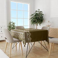 Wood-brown patterned tablecloth with cream zigzag border on a dining table