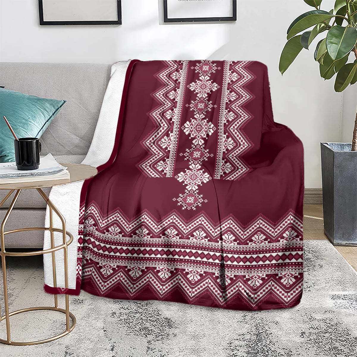 Wine red folk pattern blanket over sofa with white diamond and zigzag motifs