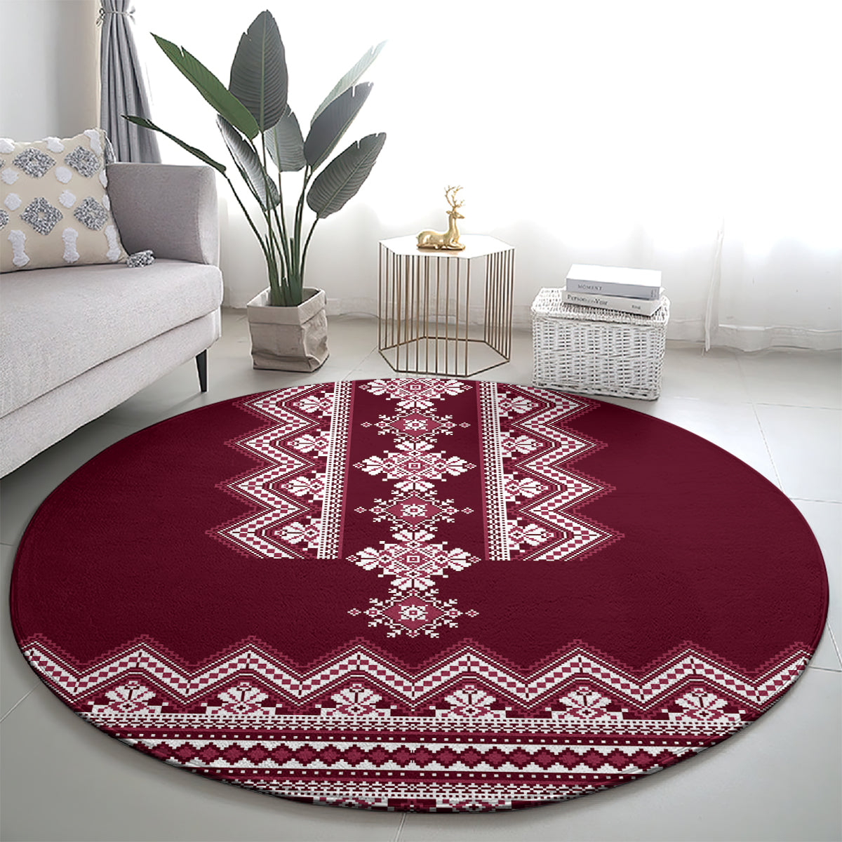 Wine red round rug featuring a white central medallion and zigzag folk border