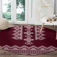 Wine red round folk rug with vertical medallion stripe and white chevron border
