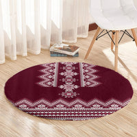 Wine red round rug with white central motif and zigzag chevron edge