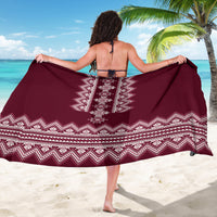 Wine red folk sarong with central white diamond motif and zigzag hem border, draped