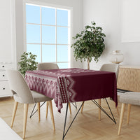 Wine red tablecloth with white geometric folk border along the table edge