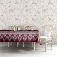 Wine red tablecloth with white Ukrainian folk pattern band across the tabletop