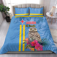 Blue duvet and two pillowcases with tropical owl, pink flowers, and yellow stripe design.