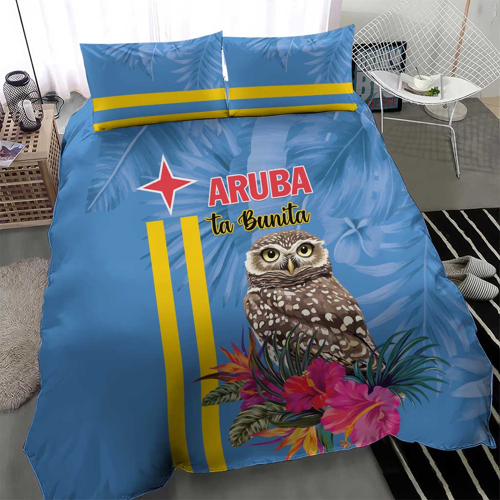 Blue duvet and pillowcases featuring a tropical owl, pink flowers, and yellow vertical stripes.