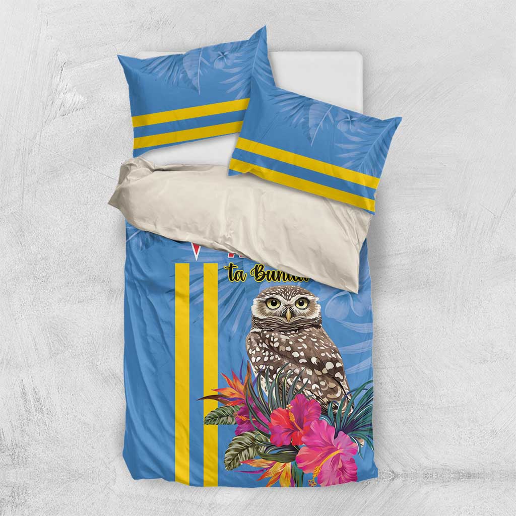 Blue duvet cover and pillowcases with tropical owl, pink flowers, and yellow stripe detailing.