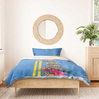 Blue duvet and matching pillowcases with tropical owl, pink floral highlights, and yellow stripes.