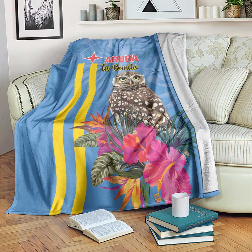Blue blanket with Aruba text, striped design, owl and tropical flowers