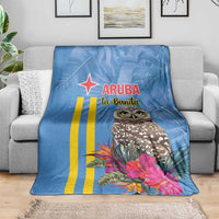 Blue throw blanket featuring Aruba text, owl portrait, and tropical blossoms