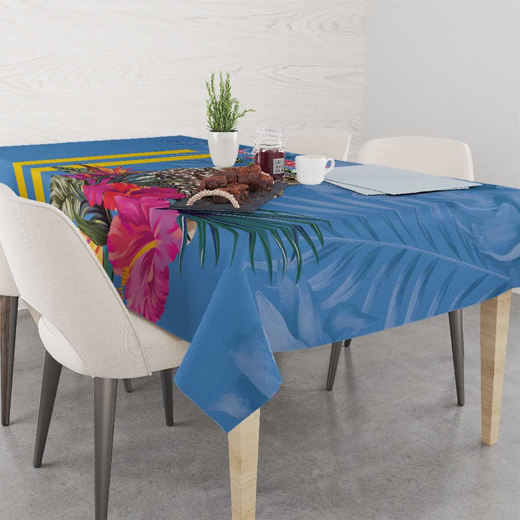 Blue tablecloth with yellow stripes and large pink floral leaves