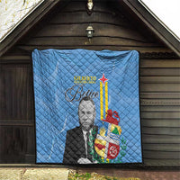 Blue quilt blanket hanging on wall, quilted texture with portrait and Aruba-style flag graphic