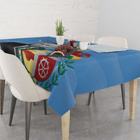 Blue Aruba flag-style tablecloth draped over rectangular dining table with colorful shield