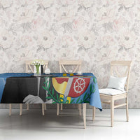 Blue Aruba flag-style tablecloth with crest center panel on dining table