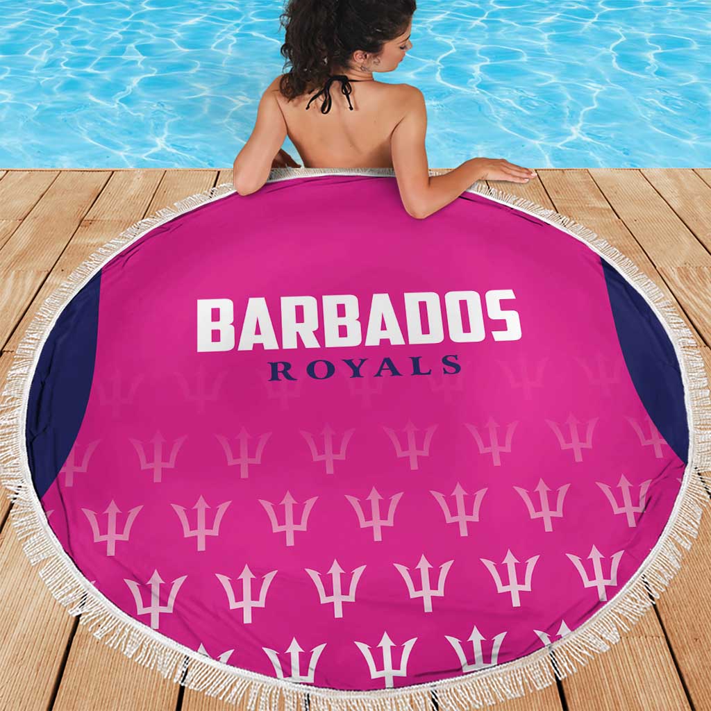 Pink round beach blanket showing Barbados Royals logo and white fringe border