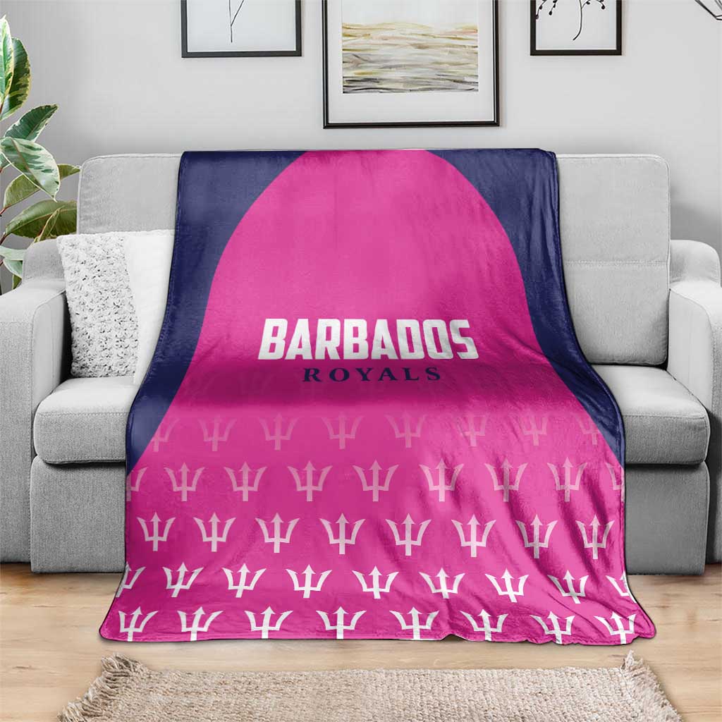 Pink and navy cricket blanket on sofa with BARBADOS ROYALS emblem and white trophy print