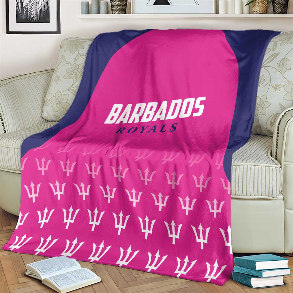 Pink and navy cricket blanket with BARBADOS ROYALS text and white trophy icons on sofa