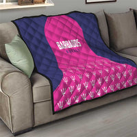 Navy and pink quilted blanket with “Barbados Royals” print and repeating trophy pattern.