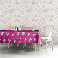Pink tablecloth with white bat pattern on long dining table with chairs