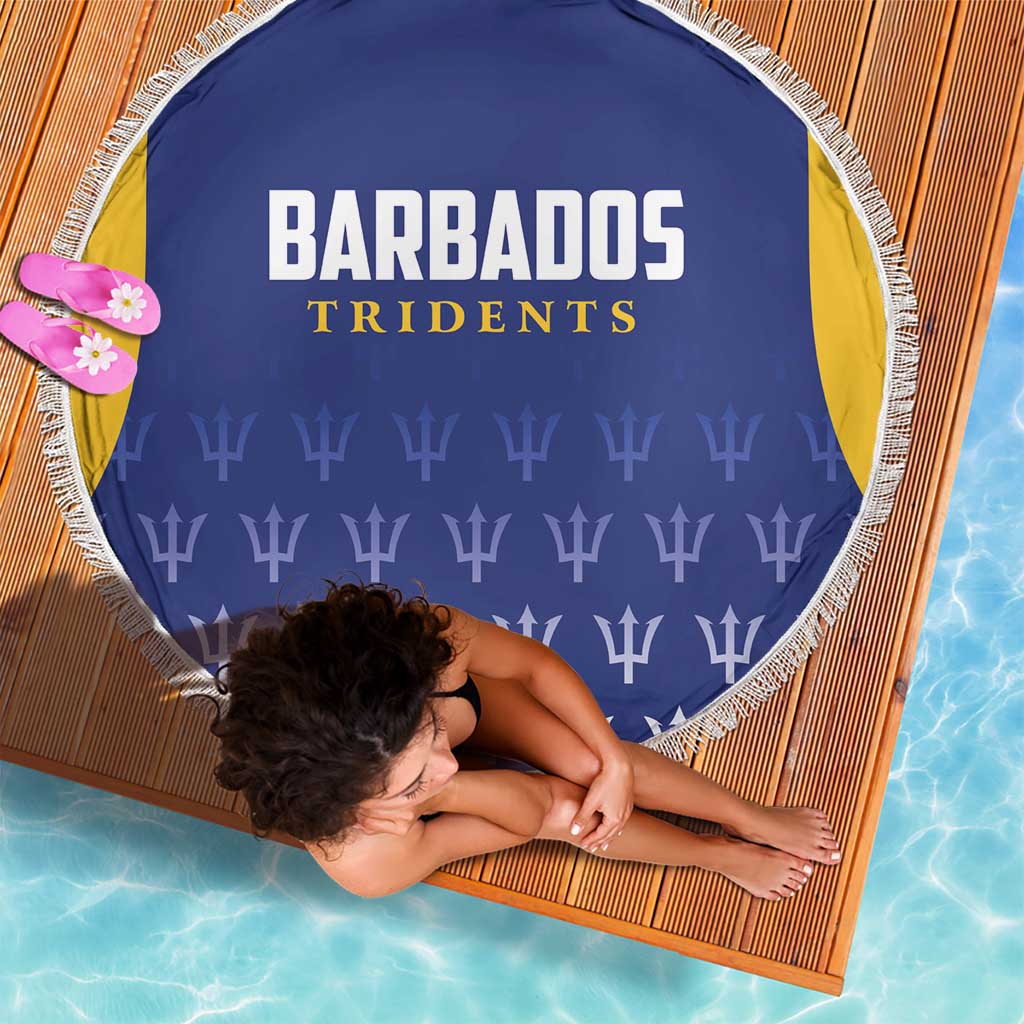 Round blue beach blanket with Barbados Tridents logo and repeating trophy icons, white fringe