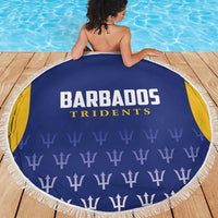 Blue beach blanket back view with Barbados Tridents lettering and trophy pattern, white fringe