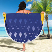 Blue round beach blanket held open with Barbados Tridents trophy pattern, white fringe trim