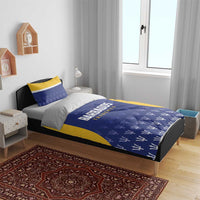 Barbados Tridents cricket bedding set on bed: blue duvet with yellow trim and logo