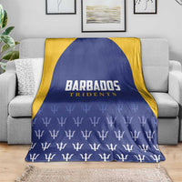 Barbados Tridents cricket blanket draped over sofa, blue with yellow trim and trophy print
