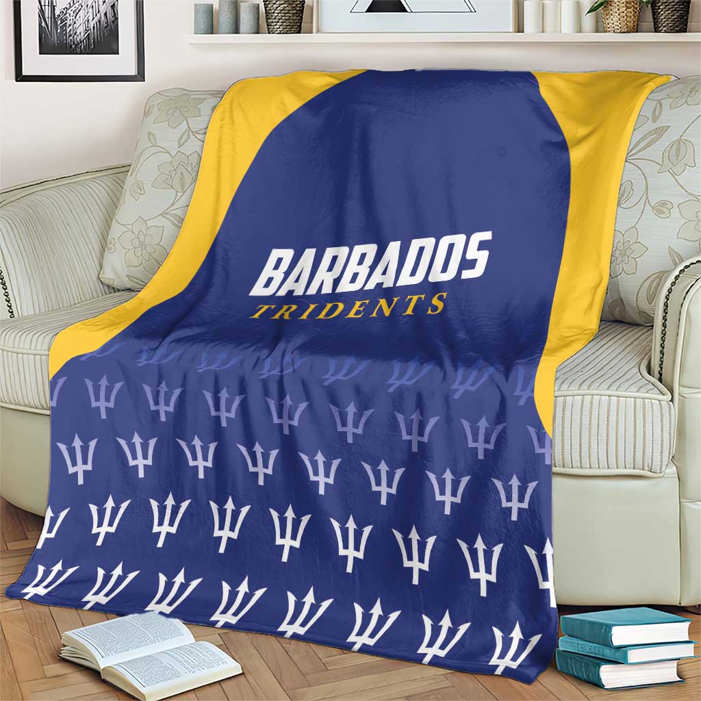 Barbados Tridents cricket blanket on armchair, blue center with yellow border and logo