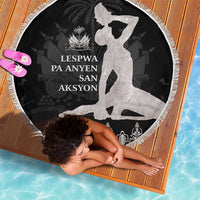 Round black beach blanket with white silhouette figure, fringe trim, and script text