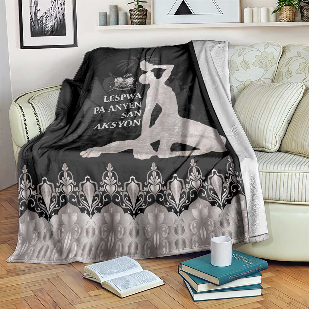 Silver and dark blanket with white silhouette and decorative border on couch