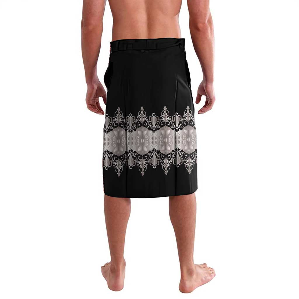 Black board shorts with elastic waistband and silver ornate border at the hem