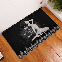 Black rubber doormat with silver silhouette, central Haitian text, and ornate floral border