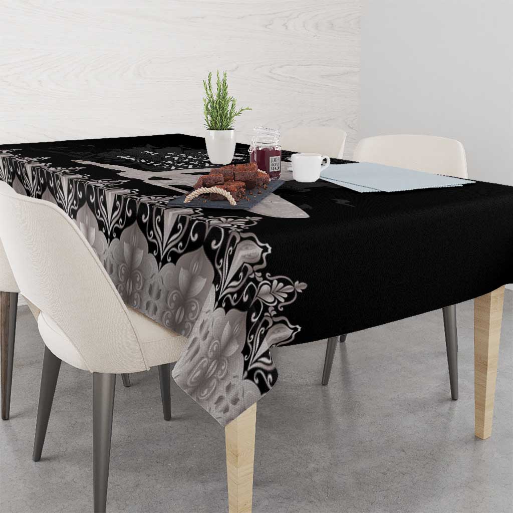 Silver and black patterned tablecloth with ornate scrolls and floral motifs