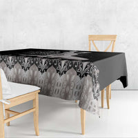 Silver tablecloth featuring black ornamental border and textured center pattern