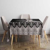 Silver tablecloth with black damask-style scroll pattern across tabletop